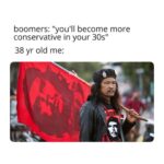 boomers: "you'll become more conservative in your 30s" 38 yr old me: Photo of a long haired man in black baret, black jacket, black, red and white shirt with picture of Che Guevara. Man is holding a big red Che Guevara flag on his shoulder.