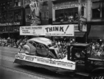 Vancouver Traffic Safety Committee float, 1953 P.N.E. Parade, crushed car. Sign: "This years fatalities: Polio 2, traffic 23. THINK! Vancouver Jaycee Traffic Safety Commitee" Another sign: "Speed kills. Obstruction means destruction."