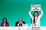 Licypriya Kangujam holding a sign "End Fossil Fuel. Save Our Planet and Our Future!" at COP28