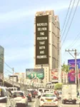 Billboard overlooking congested auto traffic reads: "Bicycles deliver the freedom that auto ads promise."